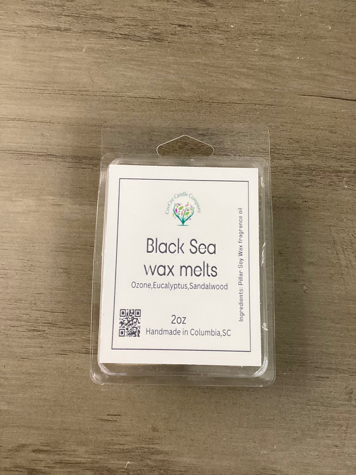 A Build Your Own Wax Melts Bundle from CeeCee Candle Company sits on a wooden surface. The label highlights scents like ozone, eucalyptus, and sandalwood and notes these handmade melts are crafted in Columbia, SC.