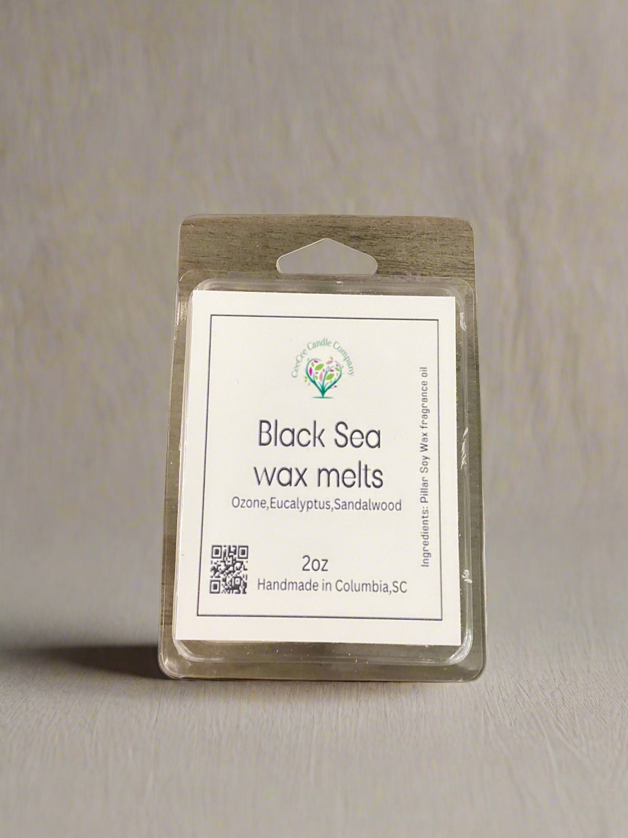 A pack of CeeCee Candle Company's Heart Shaped Wax Tarts rests on a neutral surface. Handmade in Columbia, SC, these 2oz soy wax melts blend ozone, eucalyptus, and sandalwood scents and feature two QR codes for more details.