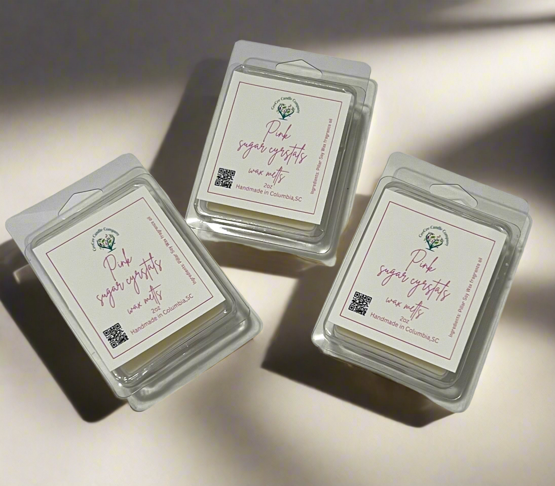Three packages of "Heart Shaped Wax Tarts" by CeeCee Candle Company are displayed on a light surface, each with a white label featuring pink text, a small green plant illustration, QR code, and location details.